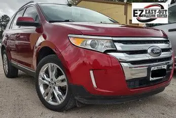 Red Ford Edge SUV with chrome accents parked outdoors.