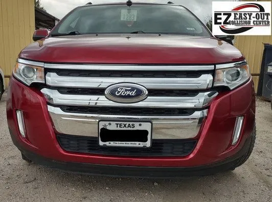 Red Ford Edge SUV with Texas license plate parked outside.